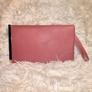 Blush pink faux leather wristlet with gold plate on the side. 
 SMOKE FREE HOME